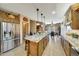 Spacious kitchen featuring a large granite island and custom cabinets with stainless appliances at 25767 N 67Th Dr, Peoria, AZ 85383