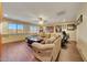 Open living area with a comfortable sectional sofa, a ceiling fan, and plenty of natural light at 25767 N 67Th Dr, Peoria, AZ 85383