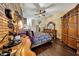 Main bedroom with ceiling fan, exposed brick wall, and hardwood floors at 25767 N 67Th Dr, Peoria, AZ 85383