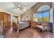 Spacious main bedroom with brick accent wall, ceiling fan, and natural lighting at 25767 N 67Th Dr, Peoria, AZ 85383