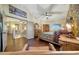Main bedroom featuring exposed brick wall, ceiling fan, and wood flooring at 25767 N 67Th Dr, Peoria, AZ 85383