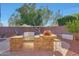 Backyard featuring an outdoor kitchen with stone counter, grill, pizza oven, and bar seating at 25767 N 67Th Dr, Peoria, AZ 85383
