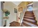 Stairway with wood steps, white railing, and decorative artwork along the walls at 25767 N 67Th Dr, Peoria, AZ 85383