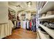 Spacious walk-in closet with custom shelving and wood-look flooring providing an abundance of storage space at 25767 N 67Th Dr, Peoria, AZ 85383