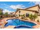 Beautiful backyard with a pool, desert landscaping, and outdoor seating at 27071 N 172Nd Ln, Surprise, AZ 85387