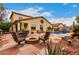 Inviting backyard with a pool, fire pit, and desert landscaping at 27071 N 172Nd Ln, Surprise, AZ 85387