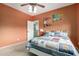 Bedroom featuring baseball-themed decor, light-orange walls, and a comfortable bed at 27071 N 172Nd Ln, Surprise, AZ 85387