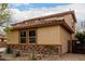 Side angle view of a two-story home with decorative stone accents and desert landscaping at 27071 N 172Nd Ln, Surprise, AZ 85387