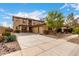 Expansive two-story home featuring a three-car garage, decorative stone accents, and a desert landscaped yard at 27071 N 172Nd Ln, Surprise, AZ 85387