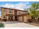 Expansive two-story home featuring a three-car garage, decorative stone accents, and a desert landscaped yard at 27071 N 172Nd Ln, Surprise, AZ 85387