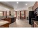 Open concept kitchen with tile floor, stainless steel appliances, dark cabinets, and view to the dining area at 27071 N 172Nd Ln, Surprise, AZ 85387