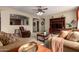 Comfortable living room featuring a ceiling fan, plush sofas, a TV, and a cozy recliner at 27071 N 172Nd Ln, Surprise, AZ 85387