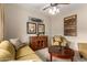 Cozy living room featuring a ceiling fan, carpet floors, and traditional decor at 27071 N 172Nd Ln, Surprise, AZ 85387