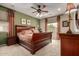 Comfortable main bedroom featuring a large bed, soft carpet, decorative curtains and a ceiling fan at 27071 N 172Nd Ln, Surprise, AZ 85387