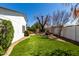 Spacious backyard with artificial turf, a fountain, hammock, and mature trees for shade at 2717 E Aster Dr, Phoenix, AZ 85032