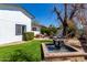Backyard oasis featuring a fountain, hammock, lounge area and manicured artificial turf at 2717 E Aster Dr, Phoenix, AZ 85032