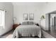 A bright bedroom with hardwood floors, a gray comforter and a cactus at 2717 E Aster Dr, Phoenix, AZ 85032