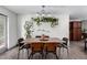 This bright dining room features a wooden table, pendant lighting and wood plank flooring at 2717 E Aster Dr, Phoenix, AZ 85032