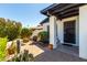 Relaxing front porch with seating surrounded by desert plants and manicured landscaping, offering a welcoming entry at 2717 E Aster Dr, Phoenix, AZ 85032