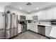 Updated kitchen with stainless steel appliances, white cabinets, and modern finishes at 2717 E Aster Dr, Phoenix, AZ 85032
