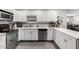 This kitchen features stainless steel appliances, white cabinetry, and tile backsplash at 2717 E Aster Dr, Phoenix, AZ 85032