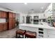 Eat-in kitchen offers stainless steel appliances, white cabinetry, tile backsplash and center island at 2717 E Aster Dr, Phoenix, AZ 85032
