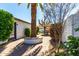 Paver patio featuring an outdoor dining area surrounded by manicured landscaping and shade at 2717 E Aster Dr, Phoenix, AZ 85032