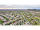 Wide aerial perspective of a community featuring tile roofs, desert vegetation, and mountain views at 28834 N 68Th Ave, Peoria, AZ 85383