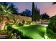 Well-maintained backyard featuring artificial turf, landscaping, and a relaxing pool area at 28834 N 68Th Ave, Peoria, AZ 85383