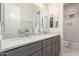 Bathroom featuring double sink vanity, marble countertop, framed mirror, and neutral paint at 28834 N 68Th Ave, Peoria, AZ 85383