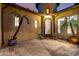 Elegant courtyard with desert landscaping, brick pavers, and an arched entry door at 28834 N 68Th Ave, Peoria, AZ 85383