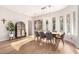 Bright dining room features stylish light fixture, wood floors, and multiple windows at 28834 N 68Th Ave, Peoria, AZ 85383