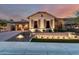 Inviting single Gathering home illuminated at dusk with desert landscaping and a two-car garage at 28834 N 68Th Ave, Peoria, AZ 85383