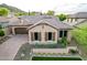 Beautiful home featuring desert landscaping, shutters, tile roof, and a brick paved driveway leading to the garage at 28834 N 68Th Ave, Peoria, AZ 85383