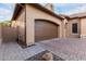 Attached two-car garage with neutral color door and matching brick paver driveway at 28834 N 68Th Ave, Peoria, AZ 85383