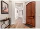 Inviting hallway with hardwood floors, art, and a decorative front door at 28834 N 68Th Ave, Peoria, AZ 85383