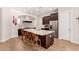 Modern kitchen with a large island, stainless steel appliances, tile backsplash, and hardwood flooring at 28834 N 68Th Ave, Peoria, AZ 85383