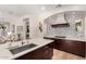 This is a gourmet kitchen with dark cabinets and marble countertop island with stainless steel sink at 28834 N 68Th Ave, Peoria, AZ 85383