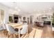Open-concept living space featuring hardwood flooring, a large kitchen island, and dining area with pendant lighting at 28834 N 68Th Ave, Peoria, AZ 85383