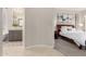 View into main bedroom and bathroom area with a bathtub and a walk-in shower at 28834 N 68Th Ave, Peoria, AZ 85383