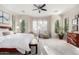 Light and airy main bedroom with a ceiling fan, large windows, and neutral decor at 28834 N 68Th Ave, Peoria, AZ 85383