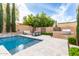 Outdoor space featuring a built in BBQ, in ground pool and a built in fire pit with ample seating at 28834 N 68Th Ave, Peoria, AZ 85383