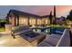 Stunning backyard pool with a fire pit, outdoor seating and beautiful home exterior at 28834 N 68Th Ave, Peoria, AZ 85383