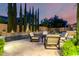 Inviting backyard pool area with travertine tile, outdoor seating, and lush landscaping at 28834 N 68Th Ave, Peoria, AZ 85383