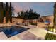 Beautiful outdoor pool with travertine tile, outdoor kitchen and landscaped entertaining area at 28834 N 68Th Ave, Peoria, AZ 85383