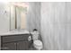 Modern powder room with a sleek vanity, decorative wall tiles, and updated fixtures at 28834 N 68Th Ave, Peoria, AZ 85383