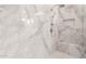 Close-up of a shower featuring elegant tiles, modern fixtures, and a built-in seat at 28834 N 68Th Ave, Peoria, AZ 85383