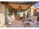 Spacious covered back patio with ceiling fan and comfortable seating, perfect for enjoying the outdoors at 29794 N Little Leaf Dr, San Tan Valley, AZ 85143