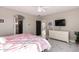 Bedroom featuring a ceiling fan, ensuite bathroom, and a TV at 29794 N Little Leaf Dr, San Tan Valley, AZ 85143