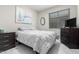 Bedroom with large window, a round mirror, and a chest of drawers at 29794 N Little Leaf Dr, San Tan Valley, AZ 85143